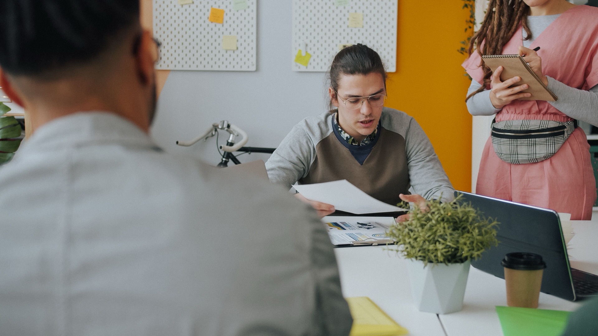A team working together across a desk in a bright office